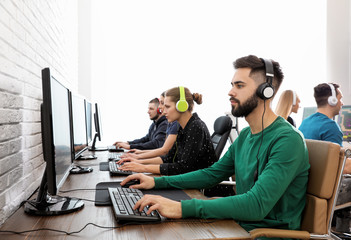 Wall Mural - Young people playing video games on computers indoors. Esports tournament