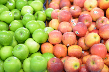 Singapore-November 29, 2018: red and green apples on store counter. Abstract background