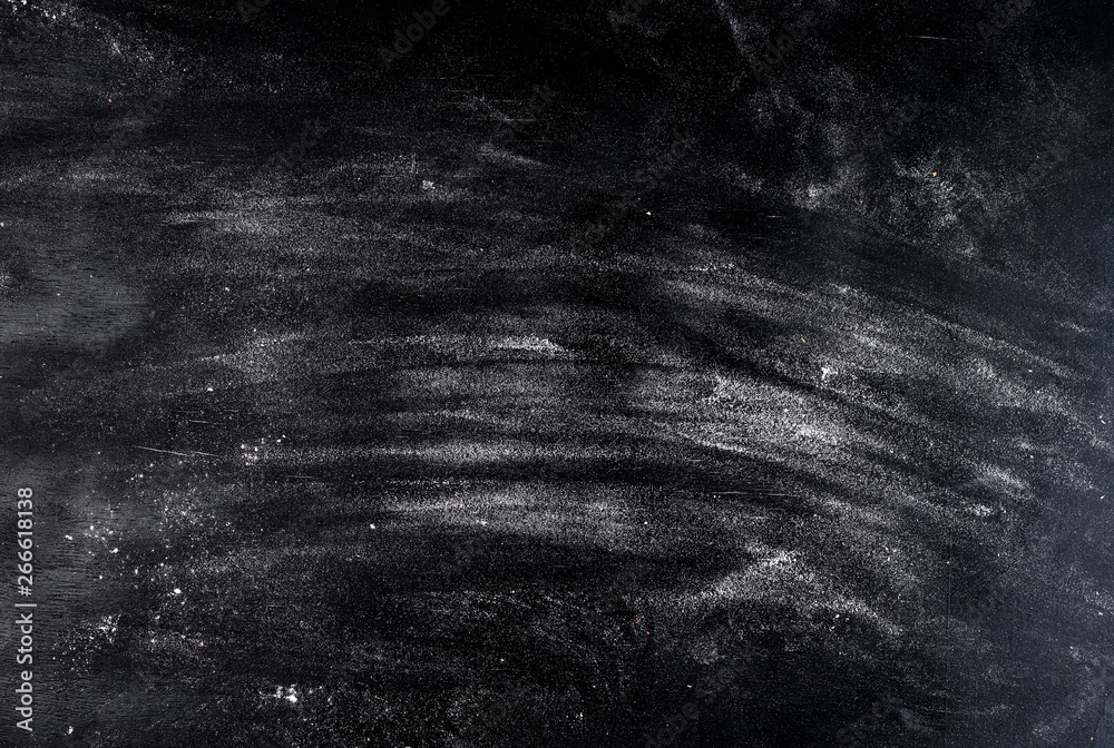 white wheat flour scattered on a black table - obrazy, fototapety, plakaty 