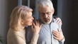 © fizkes - Grey haired man touching chest, having heart attack, woman supporting