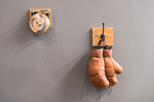 Final Sparring. Vintage Boxing Gloves Hang On Hook Wall Background. Boxing Gloves And Ring Bell. Boxing Career Famous Sportsman. Museum Of Box Sport. Box Exhibition Retro Attributes. Boxing School