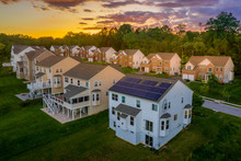 American Luxury Real Estate Single Family Houses With Brick Facade, Solar Power Roof  And Two Car Garages In A New Construction Maryland Street Neighborhood USA Aerial View