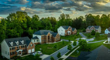 American Luxury Real Estate Single Family Houses With Brick Facade And Two Car Garages In A New Construction Maryland Street Neighborhood USA Aerial View