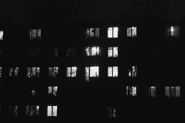 Wall Mural - black and white luminous windows of an apartment at night, where every tenant has his own privacy