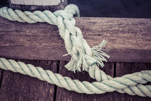 Worn Out Thick Mooring Rope On Wooden Pier Closeup