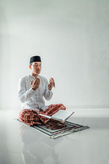 Wall Mural - religious islamic muslim asian man praying to god