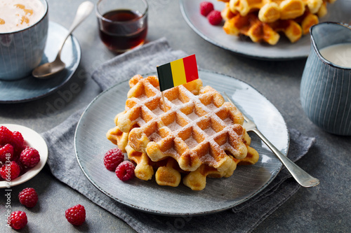Fotografía Waffles with icing sugar and Belgium flag on a plate