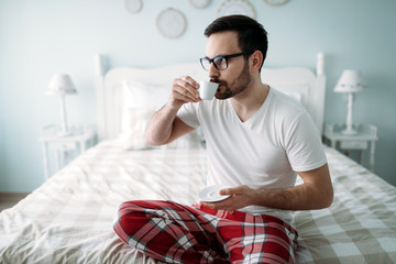 Portrait of handsome young man drinking coffee