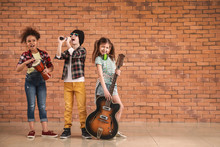 Band Of Little Musicians Against Brick Wall
