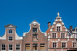 stepped gable of typical dutch houses Hoorn, The Netherlands, against blue sky