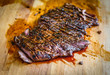 © _jure - Sliced grilled juicy marinated beef flank steak on wooden board.
