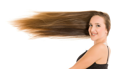  Young smiling woman with very long flying hair on white background