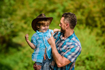 Wall Mural - Spirit of adventures. Strong like father. Power being father. Child having fun cowboy dad. Rustic family. Growing cute cowboy. Small helper in garden. Little boy and father in nature background