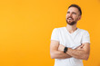 © Drobot Dean - Happy man posing isolated over yellow wall background looking aside.