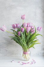 Bouquet Of Lilac Fading Tulips On A Gray Background.