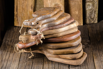 high detailed background texture kitchen chopping several many boards old vintage color of dark black with rifts and cracks, stripes one two three rings, wooden grain, abstract lie on the table