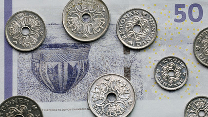 Wall Mural - Mixed Danish coins over a Danish fifty Kroner banknote - Kroner is the official currency of Denmark.