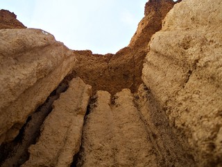 Close up shot to the edge of the earth pillar with earth texture and sky with fog an cloud at Sao Din Na Noi park, Nan, Thailand