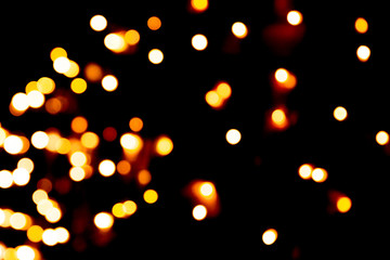 Defocused city gold night bokeh abstract background. blurred many round yellow light on dark background