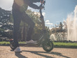 Modern Man on Electric Scooter in Sunny Park with Fountain 7 