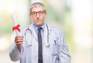 Canvas Print - Handsome senior doctor man holding degree paper over isolated background with a confident expression on smart face thinking serious