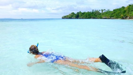 Wall Mural - Woman snorkeling on turquoise water caribbean sea Indonesia Sulawesi Wakatobi Marine National Park, coral reef tropical island tourist diving travel destination