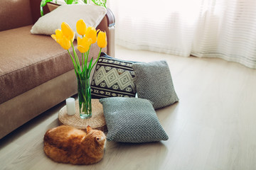 Details of modern living room interior. Tatami straw cushion decorated with flowers and pillow on the floor