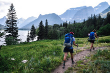 Women Backpacking In Glacier National Park In Montana During Summer