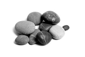 Wall Mural - Scattered sea pebbles. Heap of smooth gray and black stones isolated on white background