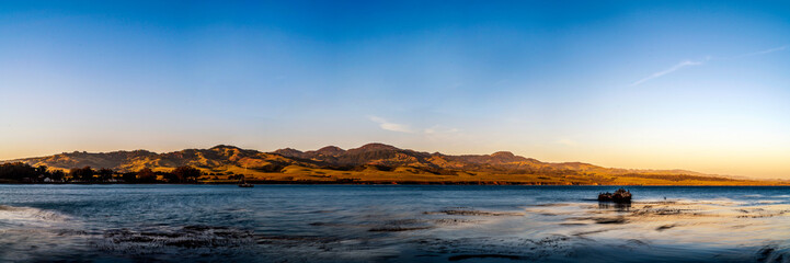 Wall Mural - Sunset panorama at the beach and mountains