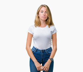 Beautiful young woman wearing casual white t-shirt over isolated background Relaxed with serious expression on face. Simple and natural looking at the camera.