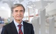 © BillionPhotos.com - Mature confident Businessman on background