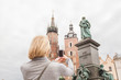 Young beautiful woman on the background of the St. Mary's Church in Krakow