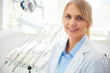 © gpointstudio - Portrait of smiling dentist in medical uniform in dentist's clinic