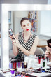 © zinkevych - Nice young woman choosing the color for eyeshadow