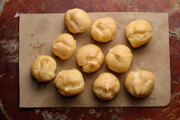 Cream puffs,Choux cream,Eclairs on the wooden table