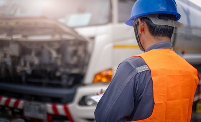 Preforming a pre-trip inspection on a truck,Concept preventive maintenance truck checklist,Check truck engine,Check the lubricating oil,spot focus.