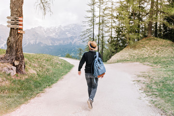 full-length portrait from back of walking male traveler enjoying italian nature during vacation. you