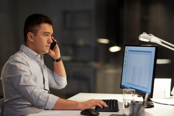 business, deadline and technology concept - businessman with computer calling on sartphone at night office