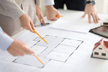 Poster - architecture, construction business and people concept - close up of architects discussing blueprint of house project at office