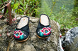 Traditional Chinese slippers perched on a rock in a natural setting in rural China