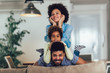 © Mediteraneo - Happy family posing on the couch together at home in the living room, selective focus.