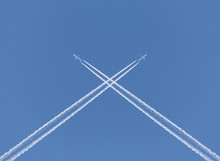 Crossing Of Two Aircraft Traces In A Blue Sky