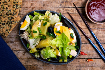 Wall Mural - Chicken salad with eggs and vegetables on a plate