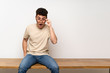 © luismolinero - Young man sitting on table with glasses and surprised