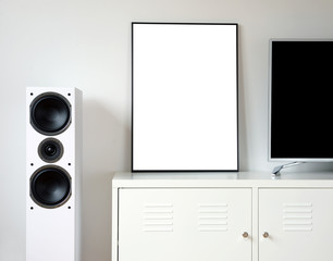 Poster Frame Mockup in white modern interior. Modern audio stereo system with white speakers on bureau in modern interior.