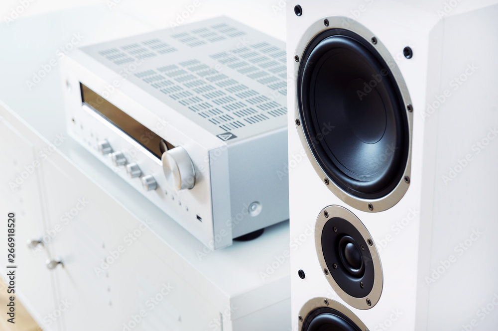 Modern audio stereo system with white speakers on bureau in modern interior - obrazy, fototapety, plakaty 