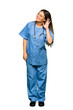 © luismolinero - Full body of Young nurse listening to something by putting hand on the ear