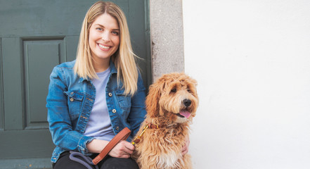 Wall Mural - Labradoodle Dog and woman outside on balcony