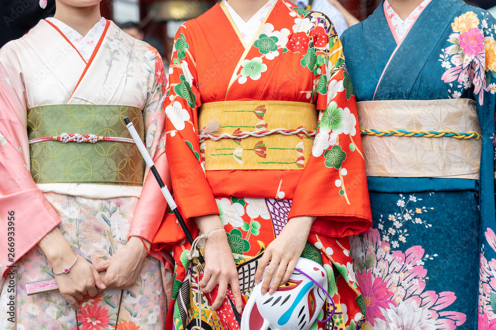 Young girl wearing Japanese kimono standing in front of Sensoji Temple in Tokyo, Japan. Kimono is a Japanese traditional garment. The word "kimono", which actually means a "thing to wear" - obrazy, fototapety, plakaty 